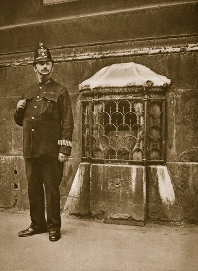 Policeman standing next to a stone set in the wall of St. Swithins, Cannon Street by English Photographer